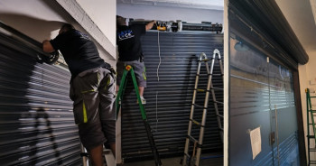 Operarios cualificados ejecutando la motorización técnica de un cierre metálico de seguridad en local comercial.
